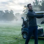 Wellness on the Green: Man warming up on a foggy golf course, practicing a swing next to a golf cart. Ideal for cold morning